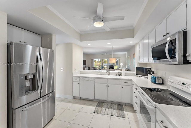 kitchen with crown molding, white cabinets, and appliances with stainless steel finishes