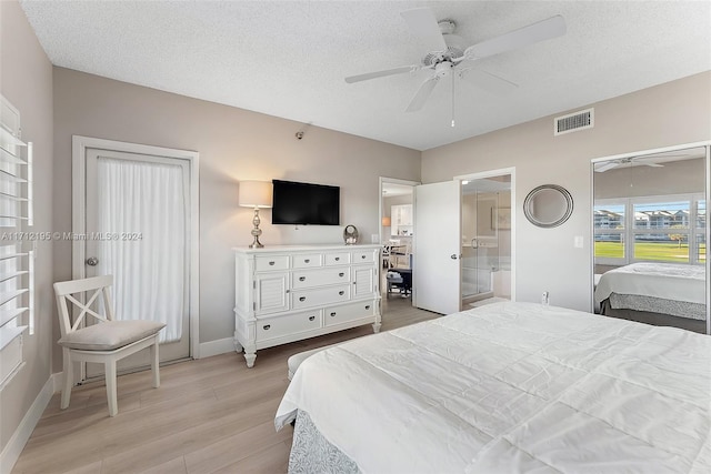 bedroom featuring a textured ceiling, light hardwood / wood-style floors, ceiling fan, and ensuite bathroom