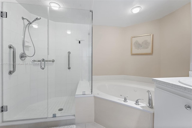 bathroom featuring tile patterned floors, vanity, and independent shower and bath