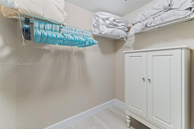 walk in closet featuring light hardwood / wood-style flooring