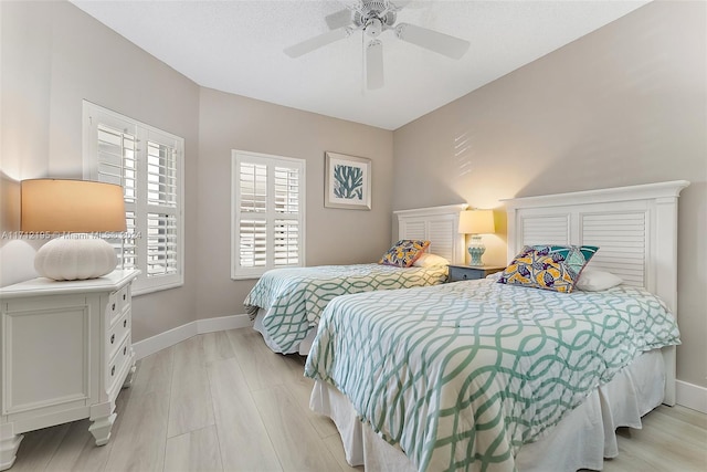 bedroom with light hardwood / wood-style flooring and ceiling fan