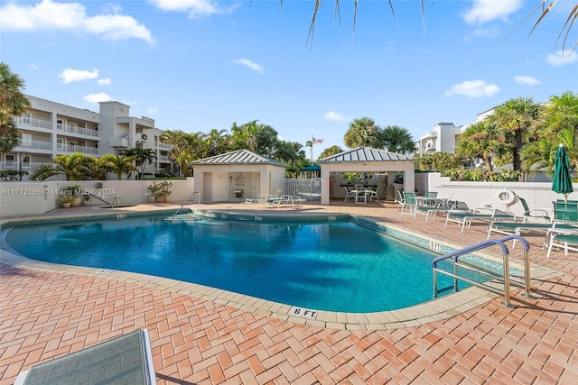 view of swimming pool with a patio area and an outbuilding