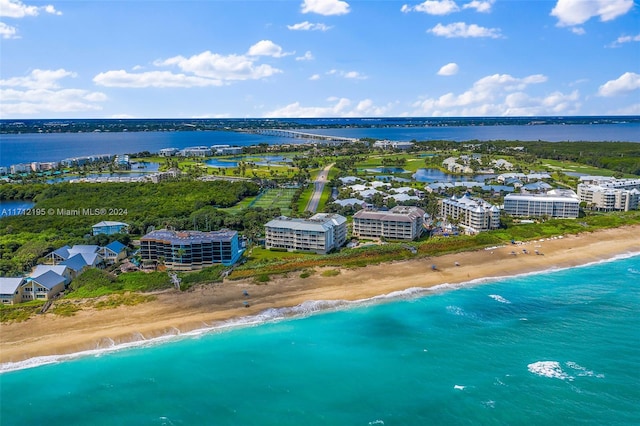 bird's eye view featuring a view of the beach and a water view