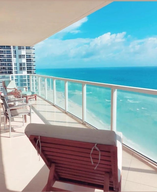 balcony with a view of the beach and a water view