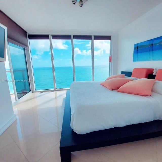 tiled bedroom featuring access to exterior and a water view