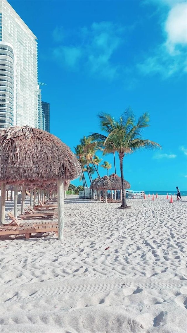 view of community featuring a view of the beach, a gazebo, and a water view