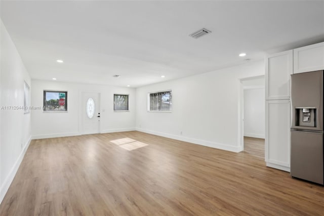 unfurnished living room with light hardwood / wood-style flooring