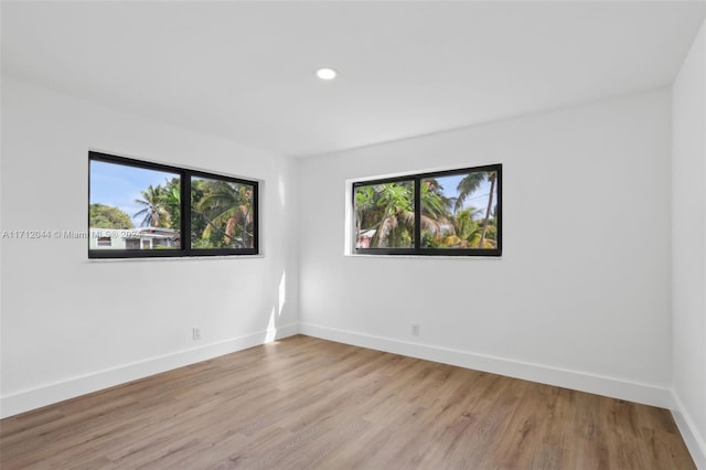 spare room with a healthy amount of sunlight and light hardwood / wood-style floors