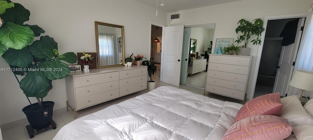 bedroom with a closet and light tile patterned floors