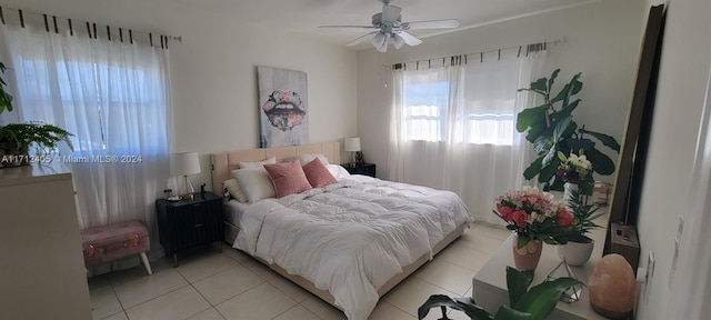 bedroom with ceiling fan and light tile patterned flooring