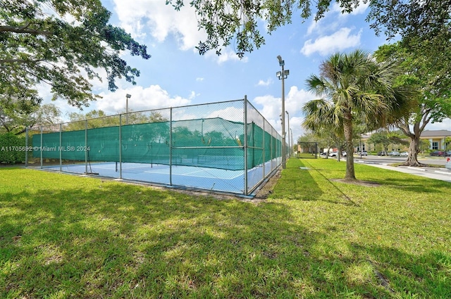 view of sport court featuring a yard