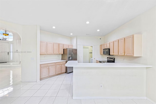 kitchen featuring kitchen peninsula, light brown cabinets, light tile patterned floors, and stainless steel appliances