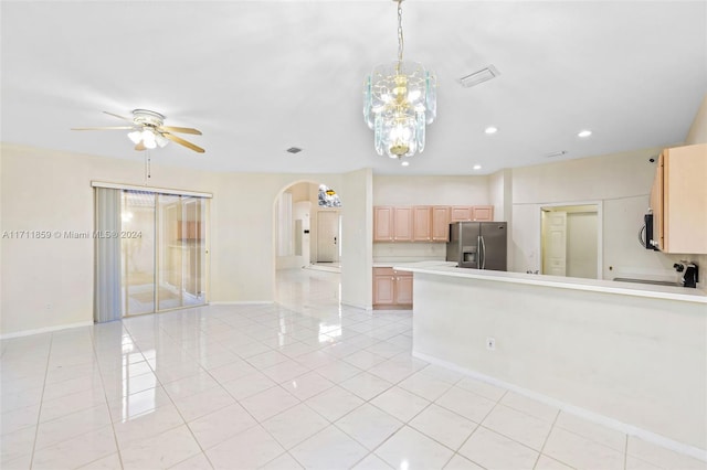 kitchen featuring ceiling fan, light brown cabinets, hanging light fixtures, light tile patterned floors, and appliances with stainless steel finishes