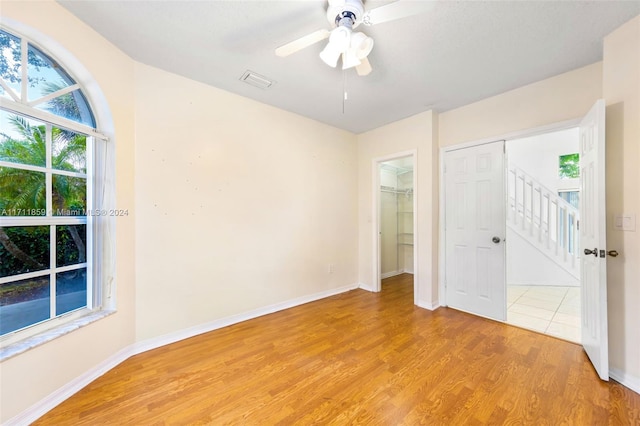 empty room featuring ceiling fan and light hardwood / wood-style flooring