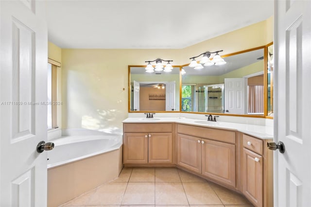 bathroom featuring plus walk in shower, vanity, and tile patterned floors