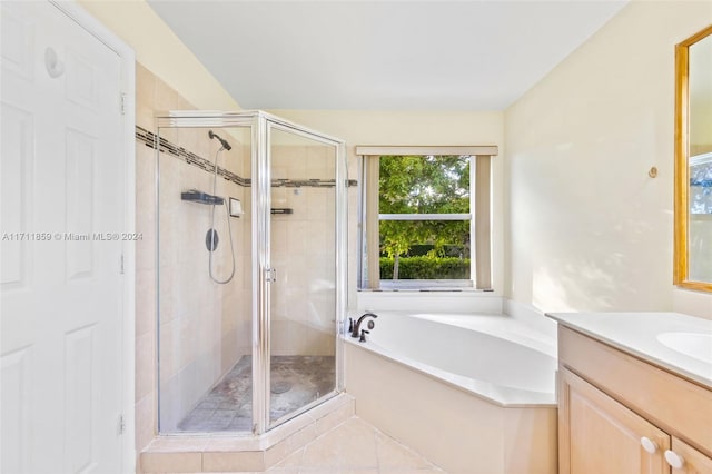 bathroom with tile patterned flooring, vanity, and separate shower and tub