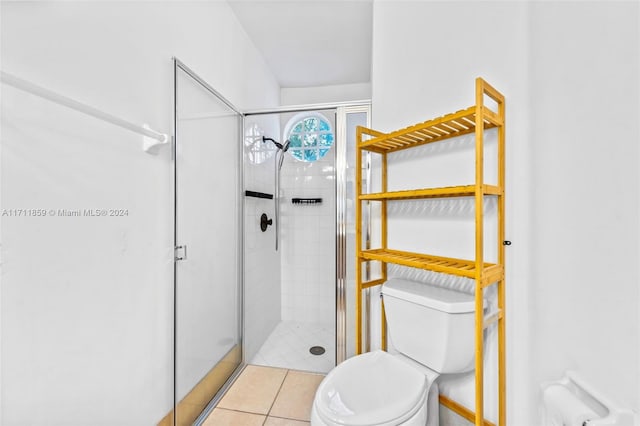 bathroom with tile patterned flooring, toilet, and walk in shower