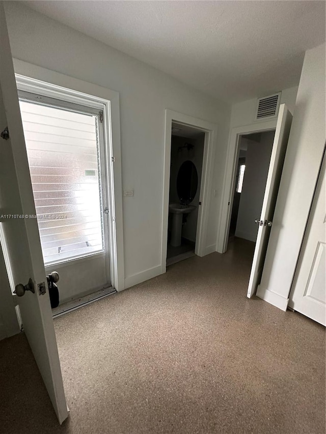 unfurnished bedroom with a textured ceiling