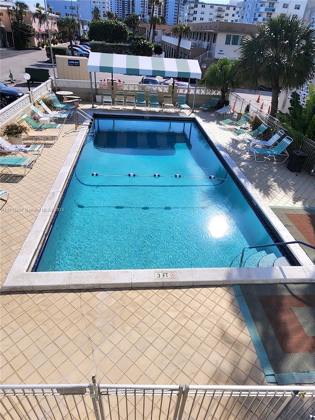 view of swimming pool with a patio