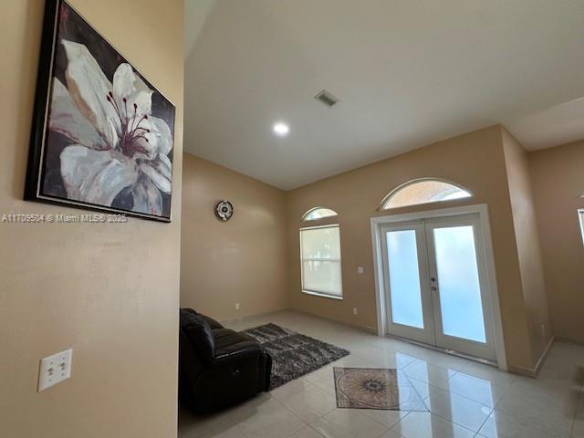 doorway with french doors and light tile patterned flooring