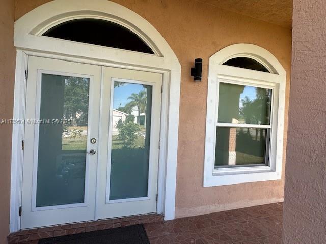 property entrance featuring french doors