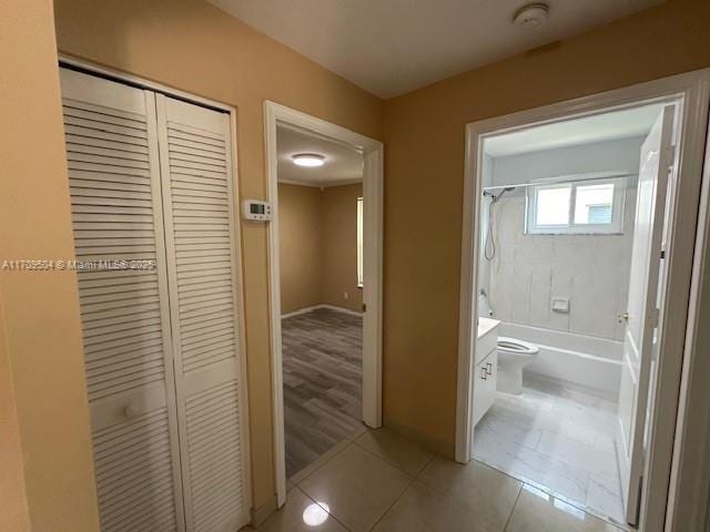 full bathroom with tile patterned floors, toilet, vanity, and tiled shower / bath combo