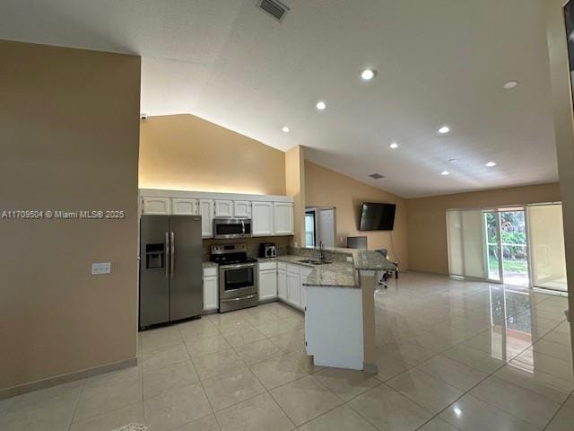 kitchen featuring kitchen peninsula, sink, white cabinetry, stainless steel appliances, and light stone counters