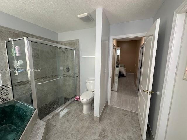 bathroom with tile patterned floors, a textured ceiling, toilet, and independent shower and bath