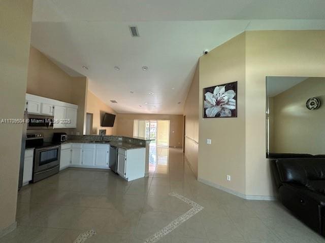 kitchen with kitchen peninsula, sink, white cabinetry, stainless steel appliances, and light tile patterned floors