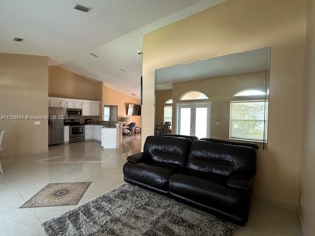 living room featuring lofted ceiling