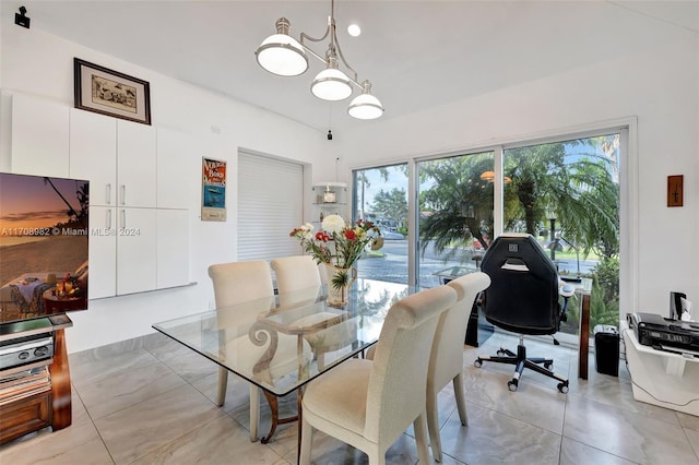 dining space featuring a healthy amount of sunlight and a chandelier