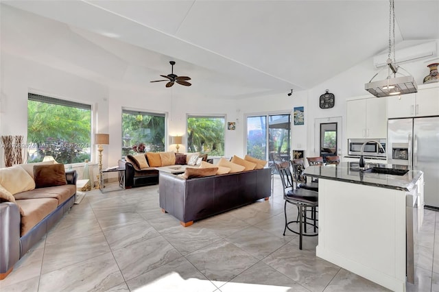 living room with sink, high vaulted ceiling, plenty of natural light, and ceiling fan