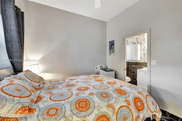 bedroom with ensuite bath and ceiling fan