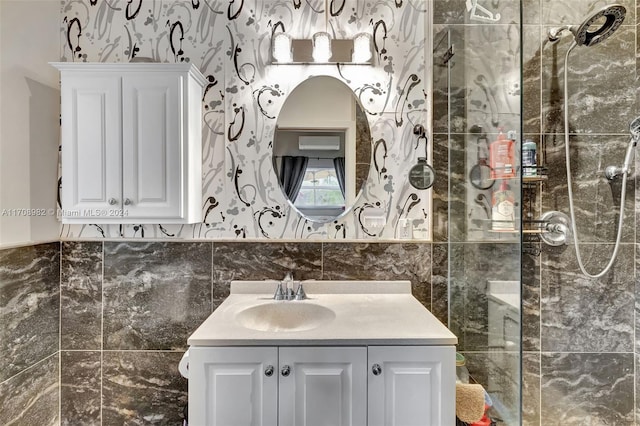 bathroom with vanity, tile walls, and walk in shower