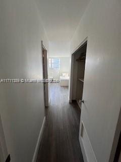 corridor featuring dark hardwood / wood-style floors