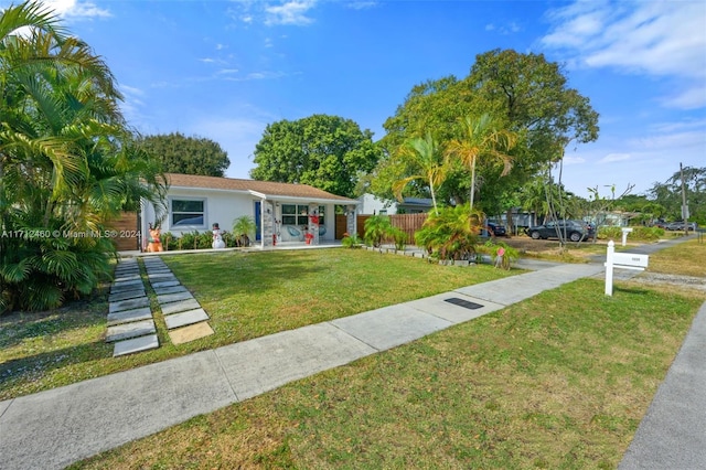 ranch-style house featuring a front lawn