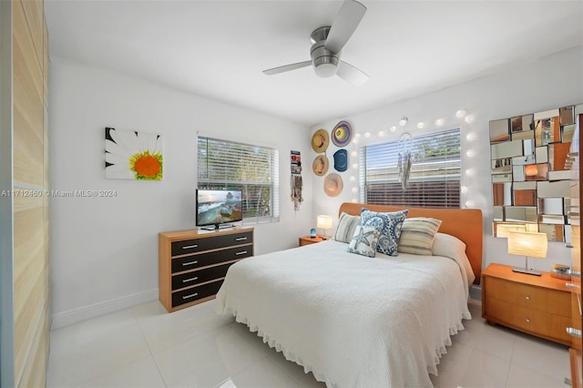 bedroom with light tile patterned flooring, multiple windows, and ceiling fan