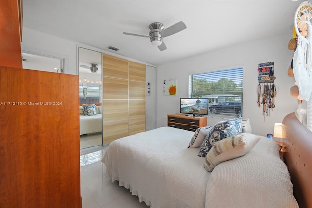 tiled bedroom with a closet and ceiling fan