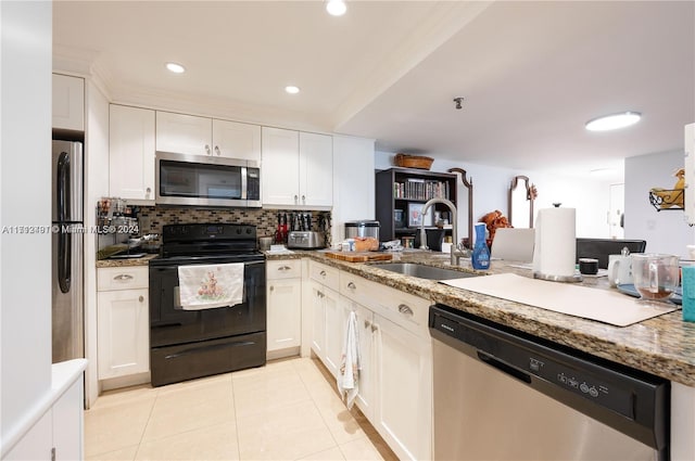 kitchen featuring white cabinets, sink, light stone countertops, light tile patterned floors, and stainless steel appliances