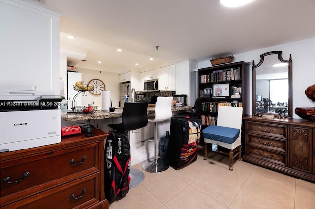 miscellaneous room with light tile patterned floors