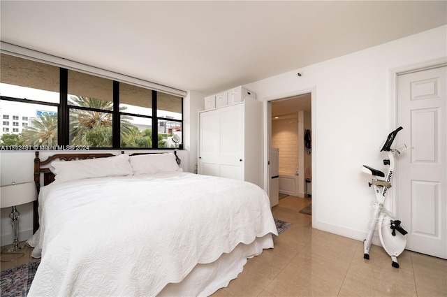 bedroom featuring light tile patterned flooring and a closet