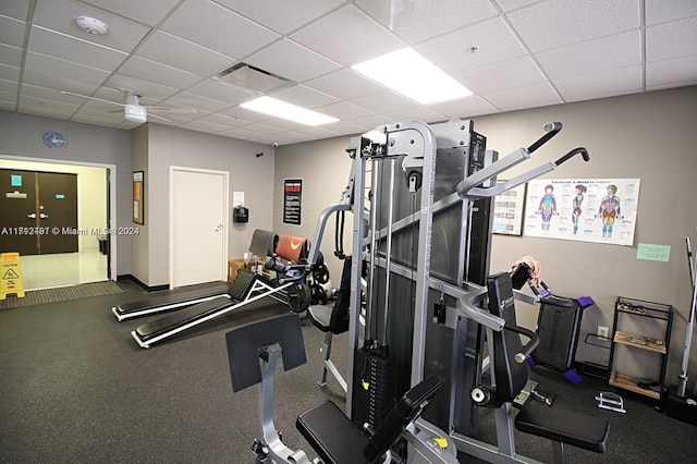 workout area featuring a paneled ceiling