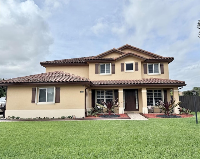 mediterranean / spanish home featuring a front yard