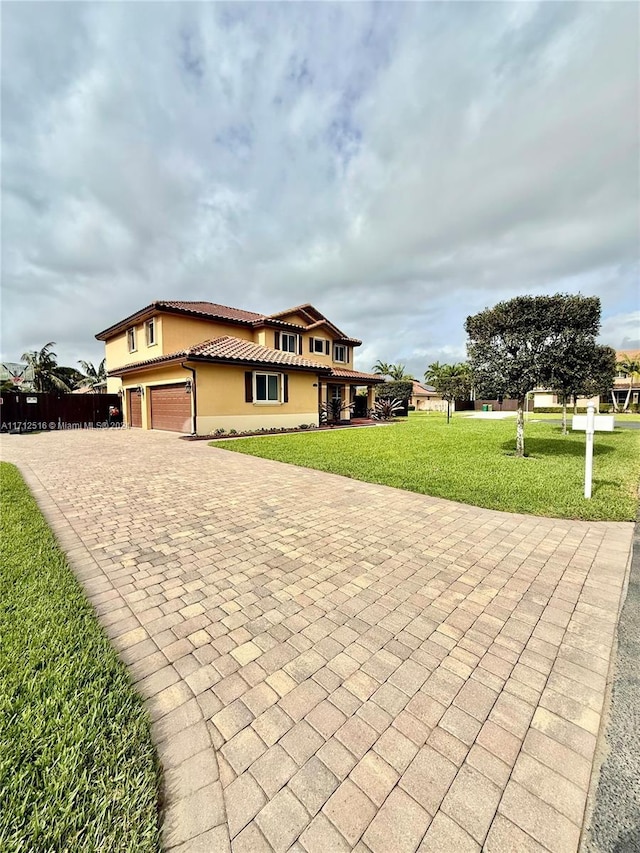 view of front of home with a front yard and a garage