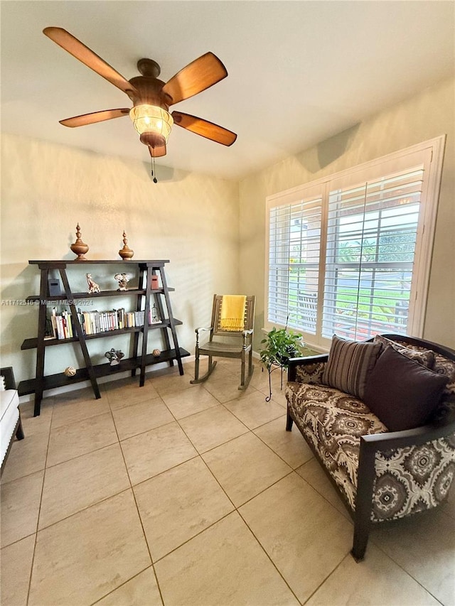 sitting room featuring ceiling fan and light tile patterned floors