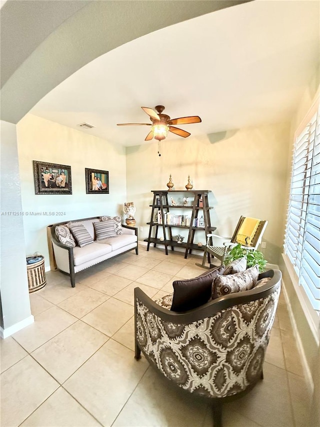 tiled living room with ceiling fan