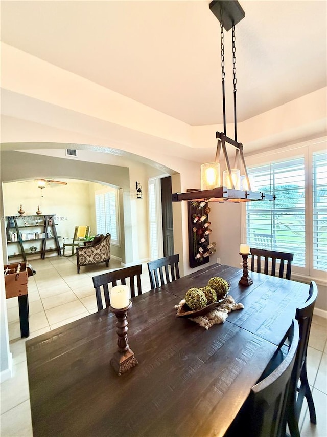 dining space with light tile patterned floors and an inviting chandelier