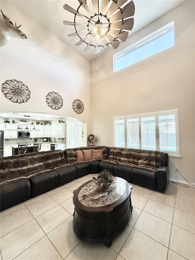 tiled living room with a high ceiling