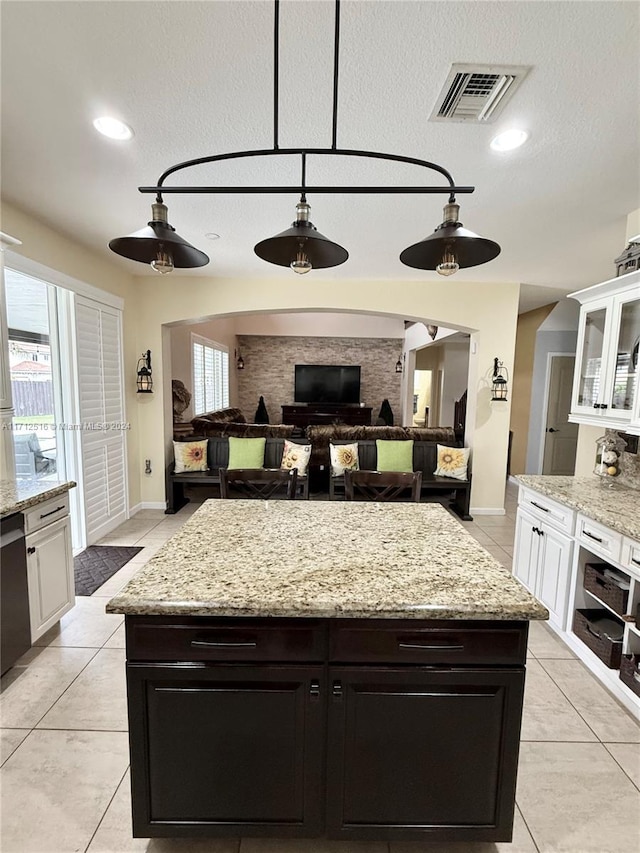 kitchen featuring ceiling fan, light tile patterned flooring, white cabinetry, and a healthy amount of sunlight