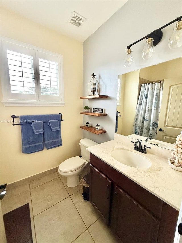 bathroom featuring tile patterned flooring, vanity, and toilet